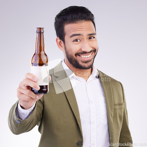 Image of Portrait of happy man with beer bottle isolated on a white background for alcohol product promotion and cheers. Professional Asian person or model face and hand holding wine glass container in studio