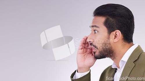 Image of Mockup, secret and Asian man with gossip, whisper and talking against a grey studio background. Japan, male and guy with privacy, space and announcement with person, sharing opinion and mysterious