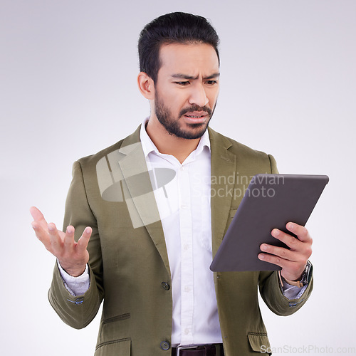 Image of Problem, confused and Asian man with a tablet for communication isolated on a white background in a studio. Unhappy, frustrated and a Japanese businessman reading bad news on technology on backdrop