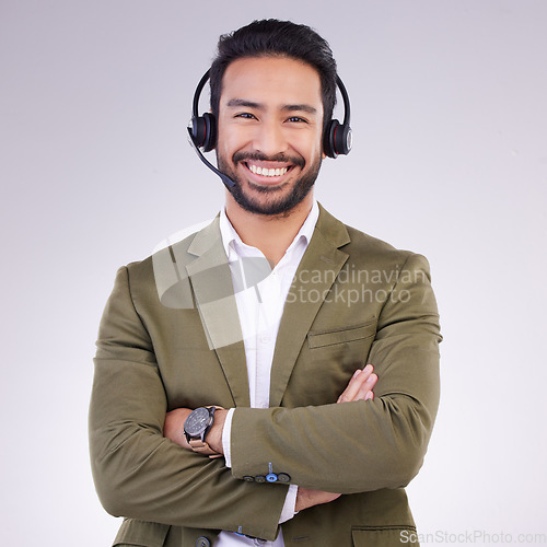 Image of Call center employee, man with smile and arms crossed in portrait, headset with mic, CRM and contact us. Communication, customer service or tech support mockup with happy male on studio background