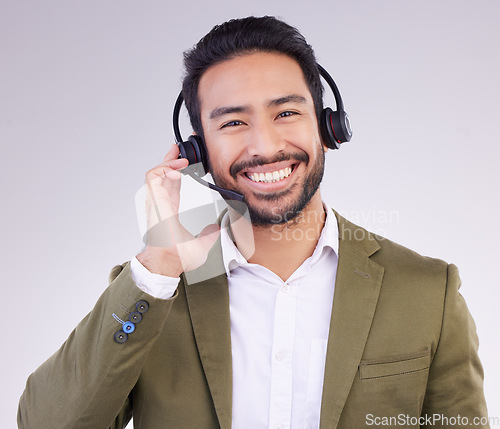 Image of Call center portrait of happy man isolated on a white background for telemarketing, telecom or global support. Asian international agent, consultant or business person for virtual salesman in studio