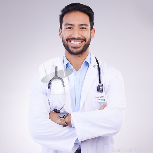 Image of Doctor, man with arms crossed in portrait and smile, health and medical professional on studio background. Male physician, cardiovascular surgeon with stethoscope, happiness in medicine and mockup