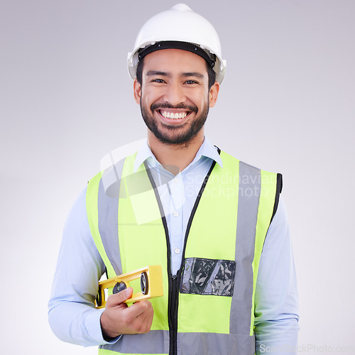 Image of Construction worker in portrait, man with tools and smile, architect or engineer in building industry on studio background. Happy male contractor, mockup and professional builder with helmet