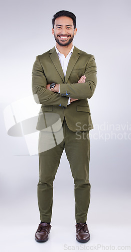 Image of Business man, smile and arms crossed portrait in studio with pride for career or job on gray background. Asian entrepreneur person with dedication and ambition for professional occupation and mindset