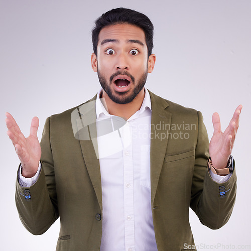 Image of Wow, shock and surprise, portrait of Indian man with hands up and shocked by amazing news or deal announcement in studio. Businessman with surprised face, emoji or meme isolated on white background.