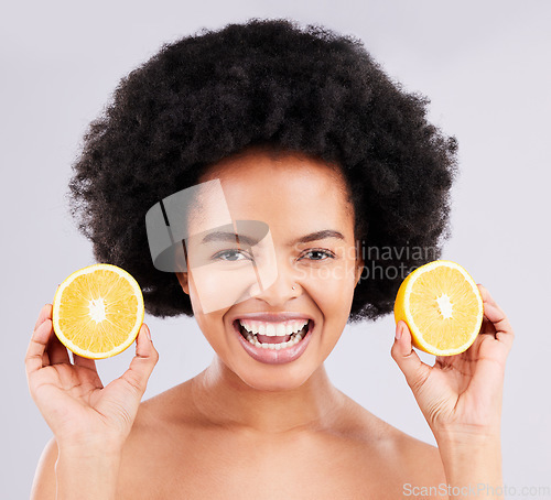 Image of Skincare, portrait and orange by black woman in studio for vitamin c, wellness or skin detox on grey background. Face, fruit and girl model excited for citrus treatment, cosmetics or beauty routine