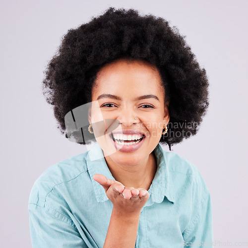 Image of Happy, laughing and portrait of a black woman blowing kiss isolated on a white background in a studio. Laugh, smile and cheerful and beautiful African girl with a gesture for love, care and flirty