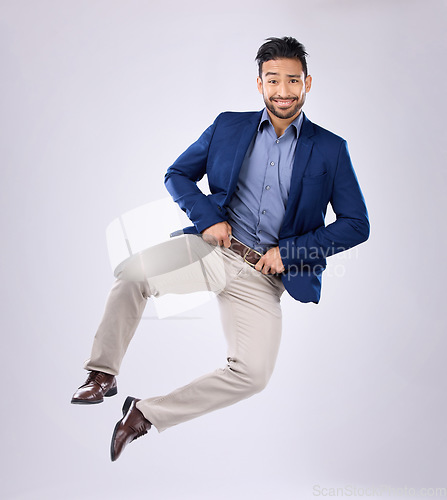 Image of Happy, crazy and portrait of an Asian man jumping isolated on a white background in a studio. Excited, smile and a Japanese businessman in the air for excitement and clicking heels on a backdrop