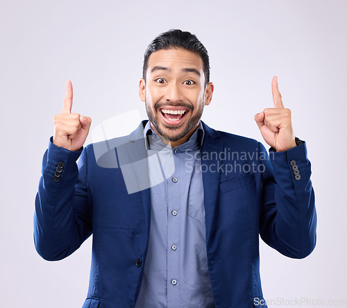 Image of Excited man, business and pointing hands at space in studio for motivation and advertising. Asian male and happy model portrait on gray background with fingers up for mockup promotion announcement