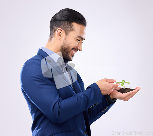 Image of Happy man with plant in hands isolated on a white background business growth or eco friendly investment. Asian person with sapling soil in palm for sustainable startup and green investing in studio