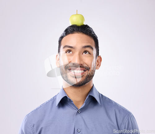 Image of Apple, head balance and man happy with fruit product for weight loss diet, healthcare lifestyle or body detox. Wellness food, studio nutritionist person and male vegan isolated on gray background