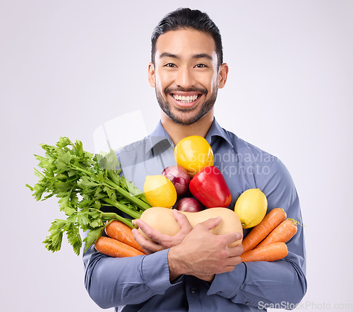 Image of Healthy, happy and portrait of an Asian man with vegetables isolated on a white background in a studio. Smile, holding and a Japanese male with food for a diet, vegan lifestyle and nutrition