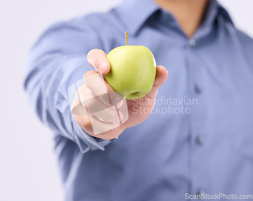 Image of Apple, studio hands and man with product for weight loss diet, healthcare lifestyle or body detox. Wellness food benefits, nutritionist person and male vegan giving fruit isolated on gray background