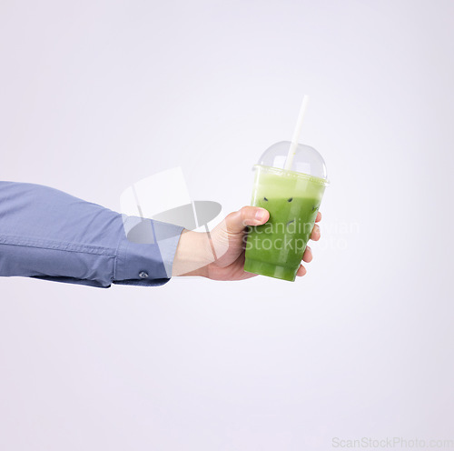 Image of Green juice in man hands isolated on a white background diet, detox and healthy breakfast or protein drink offer. Person or nutritionist hand holding or giving smoothie for vegan choice in studio