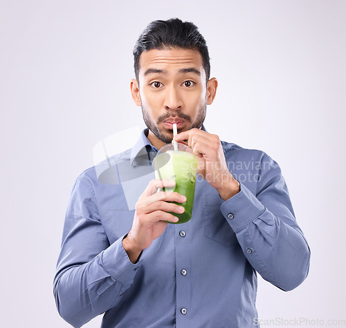 Image of Portrait of man drinking smoothie isolated on white background diet, detox and healthy breakfast choice. Asian business person with green juice for nutrition, energy protein or vegan drink in studio