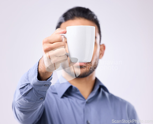 Image of Hand, coffee cup and studio with business man for drink, energy and health to start morning by background. Businessman, young entrepreneur and holding mug for tea, latte or matcha by gray backdrop