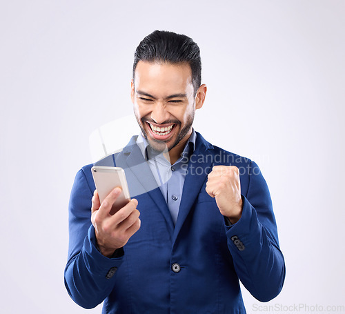 Image of Business man, phone and celebrate success in studio for winning, deal or bonus. Happy male model isolated on gray background with smartphone for mobile app or internet competition or lottery winner