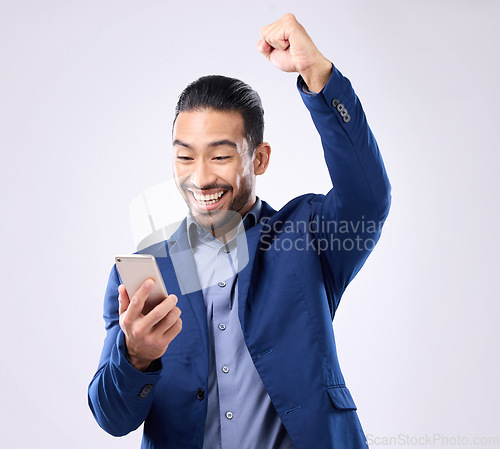 Image of Happy man, phone and celebrate success in studio for winning, deal or bonus. Business male isolated on gray background with smartphone and fist for mobile app, internet competition or lottery winner