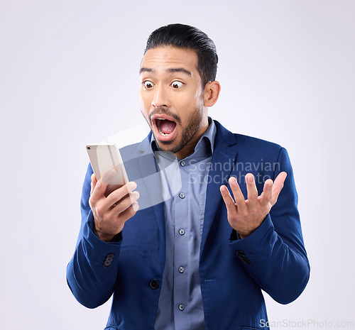 Image of Business man, phone and wow for success in studio for winning, deal or bonus notification. Excited male model isolated on gray background with smartphone mobile app, internet competition or surprise