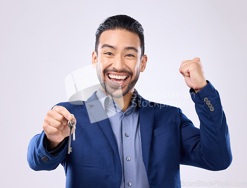 Image of Realtor man, keys and studio portrait for celebration, fist hands or smile for new home, property or background. Happy asian businessman, real estate entrepreneur excited for buying of building