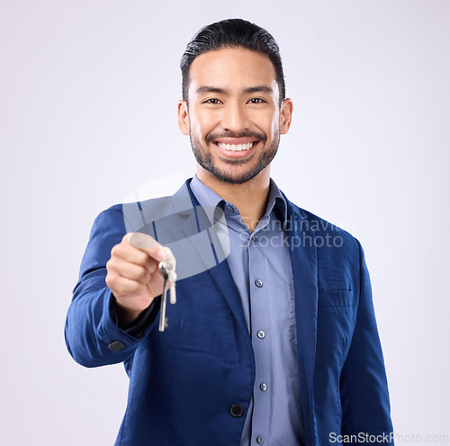 Image of Realtor man, keys and studio portrait with smile, dream and excited face for new home, house or property on background. Happy asian businessman and real estate agent for professional buying