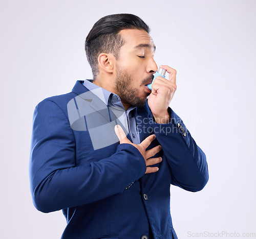 Image of Business man breathe asthma pump in studio, medical health risk and cough treatment for chest pain. Sick male worker breathing medicine inhaler for lungs, oxygen and panic attack of allergy emergency