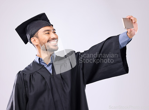 Image of Man, graduate and selfie with smile for scholarship, profile picture or social media against a gray studio background. Happy excited male academic smiling for graduation photo, memory or online post