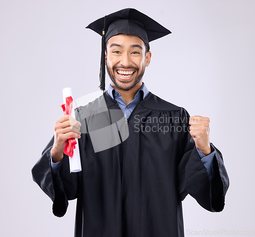 Image of Graduation portrait of asian man, certificate and success isolated on studio background for university achievement. Fist pump of happy student, person or college graduate and diploma, award and goals