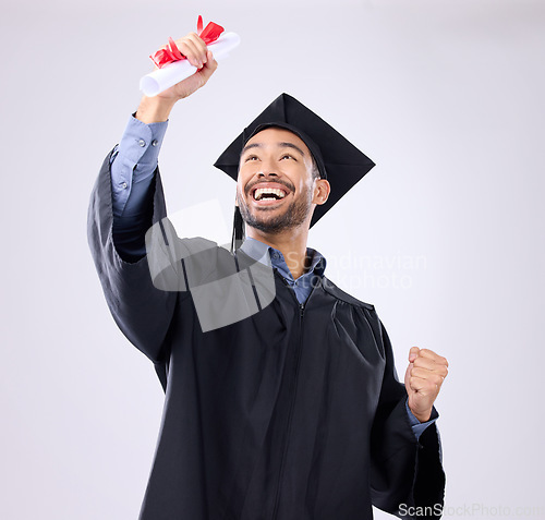 Image of Student man, celebration and diploma in studio with happiness, success and achievement of life goals. Asian guy, happy and certificate for graduation from college, university or academy with smile