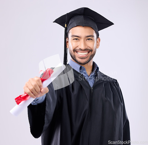 Image of Graduate man, studio portrait and diploma in hand for learning achievement, education or goal by background. Happy student, certificate or smile for success, award and excited for college graduation