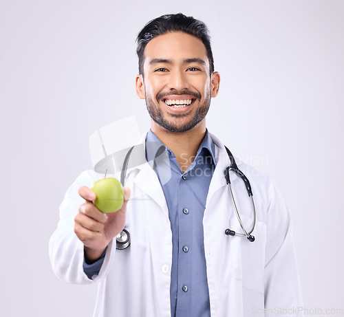 Image of Apple, doctor portrait and man happy with fruit recommendation for weight loss diet, medical healthcare or detox. Wellness, nutritionist nurse and male vegan giving food isolated on gray background