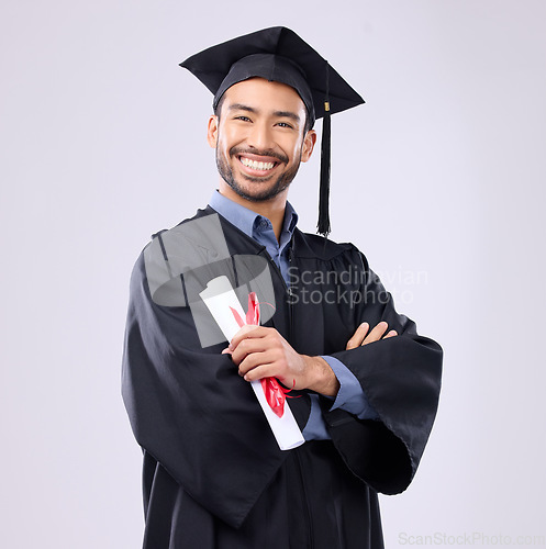 Image of Graduation man, diploma and arms crossed in studio portrait with smile, success and pride for achievement. College graduate, asian student and certificate with goals, motivation and excited for award