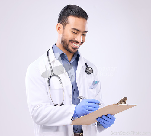 Image of Medical, happy and doctor writing on a clipboard doing a checklist isolated against a studio white background. Health, gloves and healthcare professional planning notes, results and confirm schedule