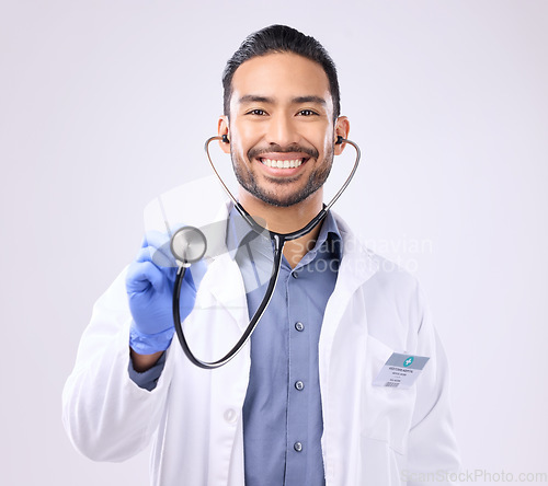 Image of Medical doctor, portrait man or stethoscope for support on healthcare, nurse work or clinic cardiology. Wellness service, studio or happy person with heart beat listening equipment on gray background