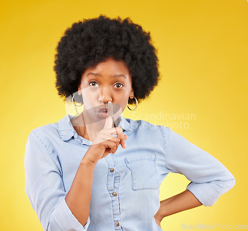 Image of Privacy, secret and finger on lips of black woman in studio for mystery, gossip and announcement. Noise, news and whisper with female and shush gesture on yellow background for rumor, drama or silent