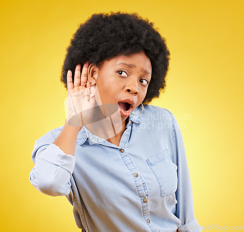 Image of Shock, secret and black woman listening in a studio with a wow, wtf or omg face expression. Gossip, surprise and curious African female model with an afro with a listen gesture by a yellow background