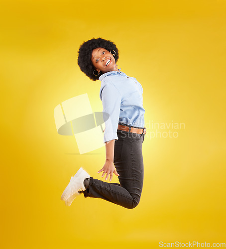 Image of Happy, excited and portrait of black woman jump on yellow background with energy, happiness and smile in studio. Winner mockup, celebration and isolated girl jumping for freedom, winning and success