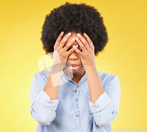 Image of Black woman, stress and hands on angry face, tired and mental health with anxiety by yellow background. Girl, frustrated and studio backdrop with mind fatigue, depression and disappointed with afro