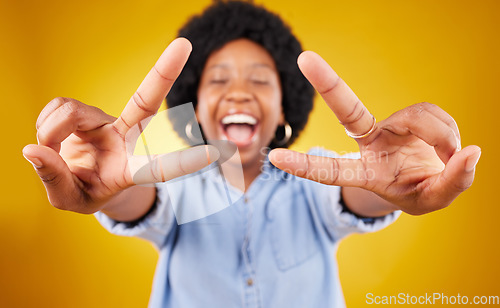 Image of Happy, excited and black woman with a peace sign in studio with positive and goofy mindset. Happiness, smile and African female model with an afro posing with a v hand gesture by yellow background.