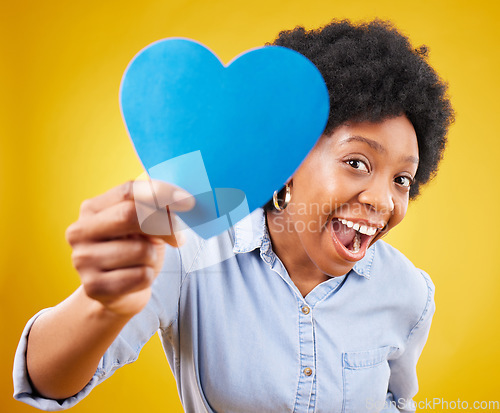 Image of Paper, heart and excited with black woman in studio for romance, positive and emotion. Happiness, love shape and giving with female isolated on yellow background for date, feelings and affectionate