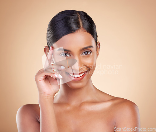 Image of Indian woman, studio and beauty with makeup, skincare treatment and happy for cosmetics by background. Model girl, young asian and smile for self love with cosmetic wellness, skin glow and aesthetic