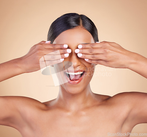 Image of Indian woman, studio and beauty with hands on eyes for surprise, happy and cosmetics by background. Gen z model girl, young asian or cover face for cosmetic wellness, natural skin glow or aesthetic