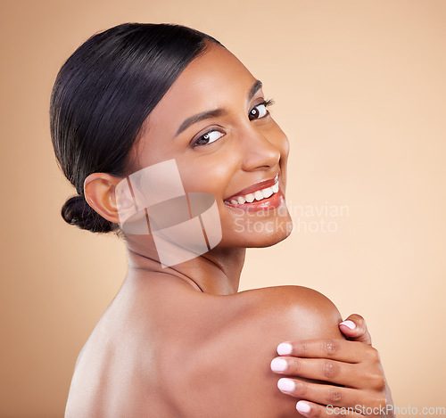 Image of Indian woman, beauty and skincare portrait with smile, looking over shoulder or wellness by background. Young asian model, gen z girl or cosmetics for natural skin glow, aesthetic makeup or happiness