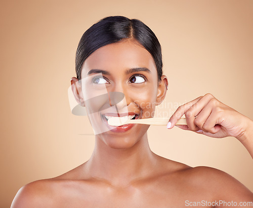 Image of Woman, thinking and brushing teeth for dental care, dentist or healthcare and skincare against studio background. Happy female hands with toothbrush for healthy clean oral, mouth or gum hygiene