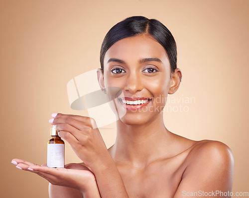 Image of Portrait, beauty and antiaging serum with a model woman in studio on a beige background to promote skincare. Face, product and collagen with an attractive young female posing for luxury cosmetics