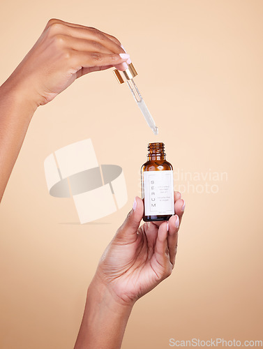 Image of Hands, serum and pipette with bottle product in studio isolated on brown background. Skincare, dermatology and woman model with cruelty free hyaluronic acid, vegan retinol or essential oil cosmetics.