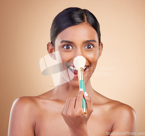 Image of Portrait of woman, funny or makeup brush for beauty, cosmetic beauty or self care in studio background. Happy, model face or crazy eyes of Indian girl with cosmetics brush, skincare or application