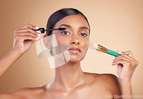 Image of Makeup brush, portrait or woman with beauty mascara, facial products or luxury self care on studio background. Model face or young Indian girl with cosmetics or natural glowing skincare application