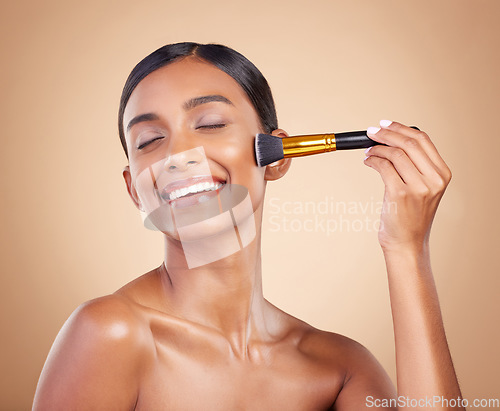 Image of Happy woman, brush or makeup artist with beauty, cosmetic products or self care on studio background. Eyes closed, model face or young Indian girl with cosmetics, glowing skincare or facial smile