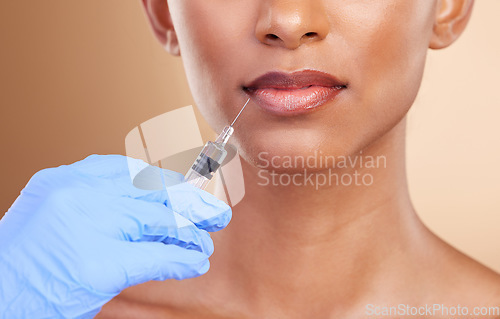 Image of Lip filler, beauty or lips of Indian woman with injection for plastic surgery, cosmetics or botox in studio. Skincare, dermatology or zoom of girl with needle in mouth, face lift or facial treatment